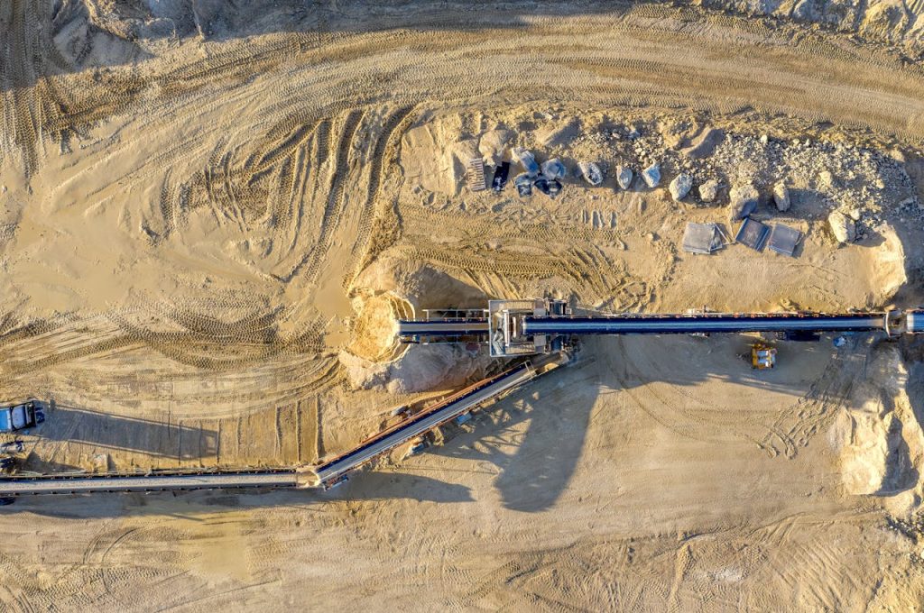 Aerial view of a construction site in Rochester, showcasing dirt excavation and heavy machinery.