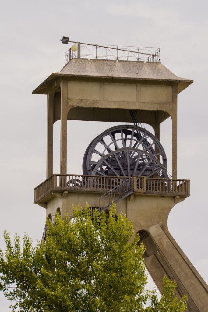 View of a historic mining tower in Maasmechelen, Vlaanderen, Belgium, showcasing industrial architecture.
